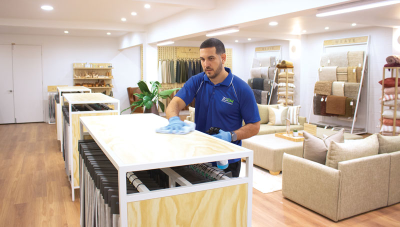 A man cleaning a showroom | featured image for the office cleaning services page.